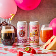 Load image into Gallery viewer, Two cans of Yonder Double Chocolate Fudge Cake beer with a slice of cake, glass of dark beer, and glass of light beer on a table with pink balloons and cake in the background.