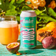 Load image into Gallery viewer, Yonder Tropical beer can with a glass of sour beer and tropical fruits on a wooden surface.