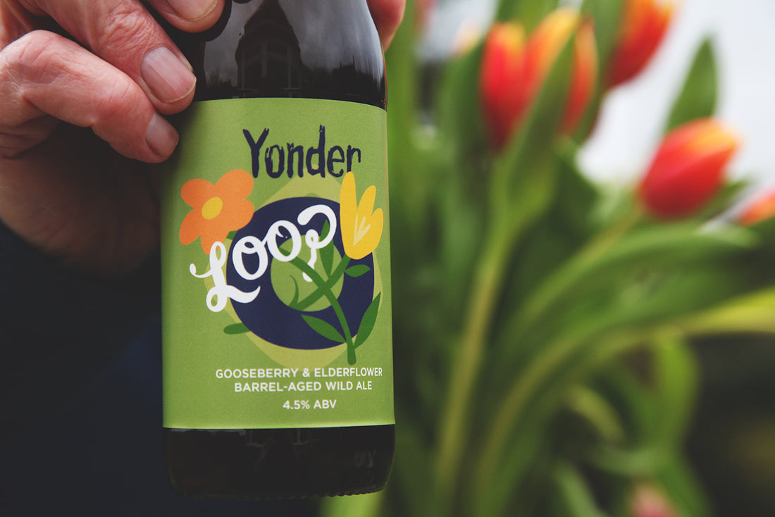 Loop Gooseberry & Elderflower - bottle of barrel aged wild ale near some flowers